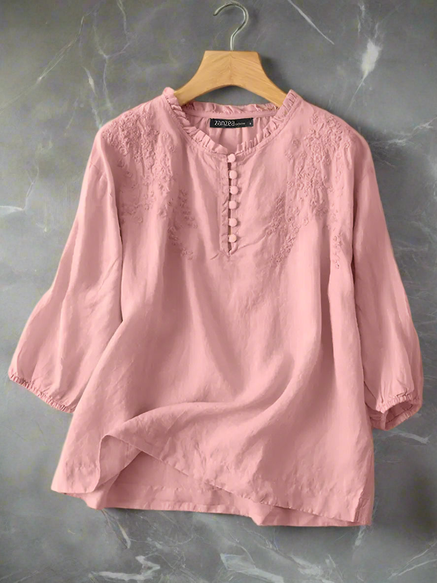 Pink blouse on a hanger with ZANZEA branding.