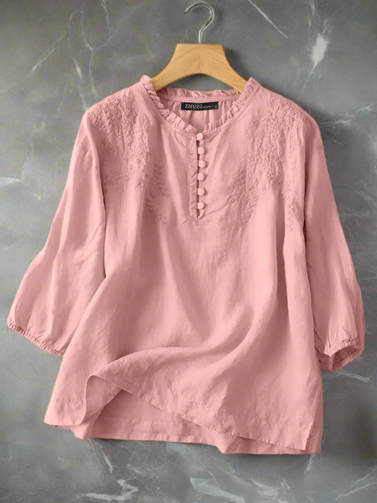 Pink blouse on a hanger with ZANZEA branding.