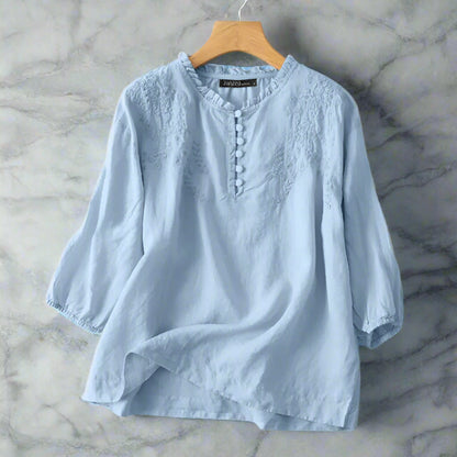 Light blue shirt on a hanger with prymee branding.