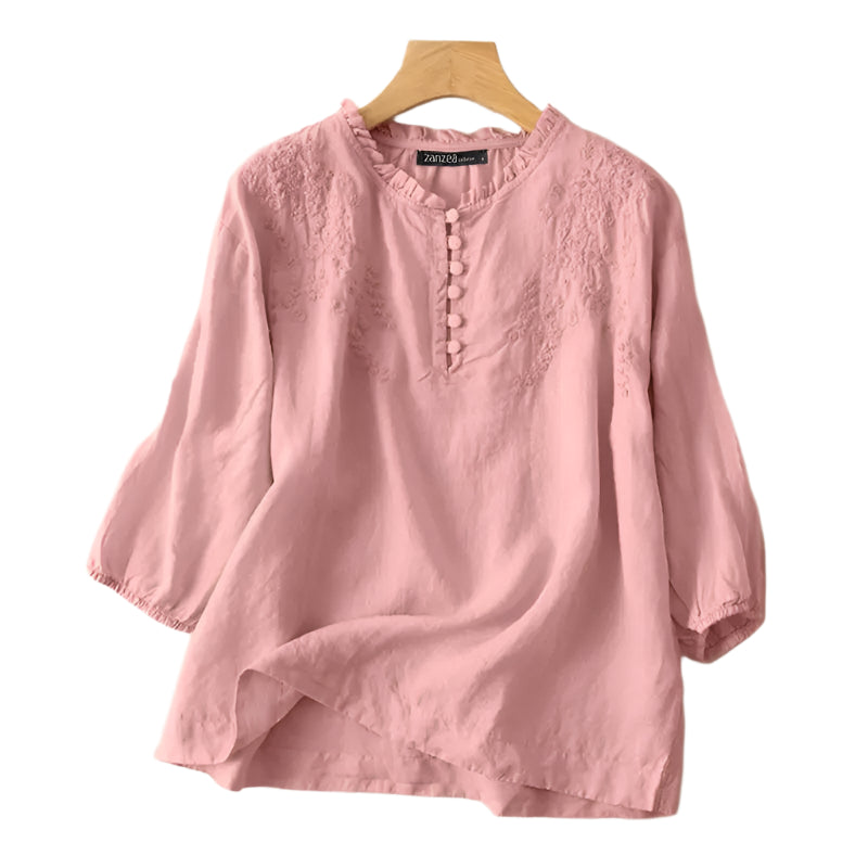 Pink blouse on a hanger with ZANZEA branding against a neutral background