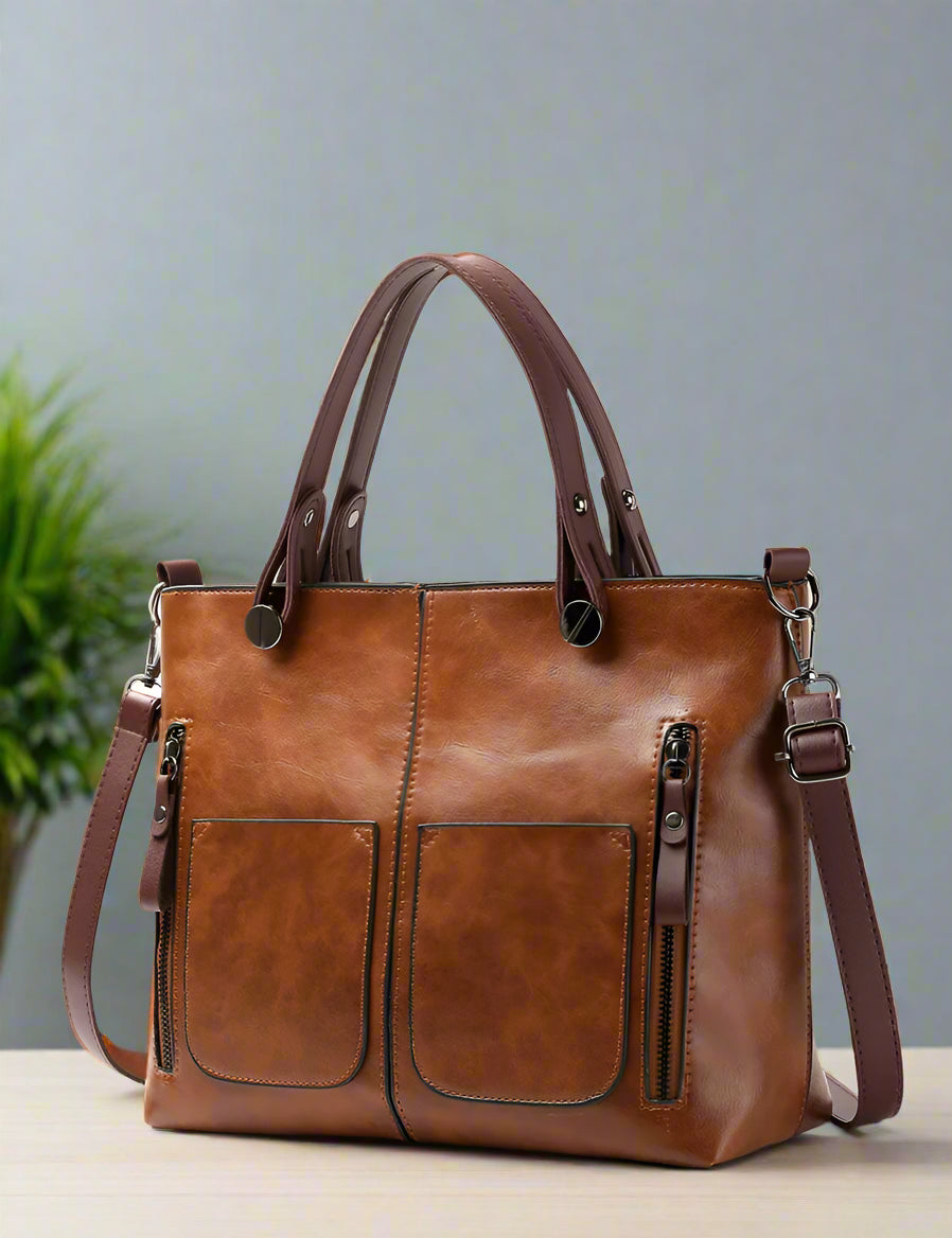 Brown leather handbag with a blurred background