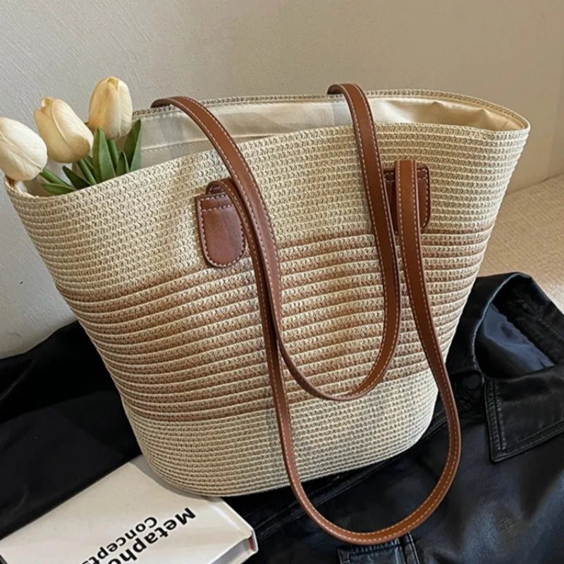 Woven handbag with brown handle and trim, containing tulips, on a dark surface.
