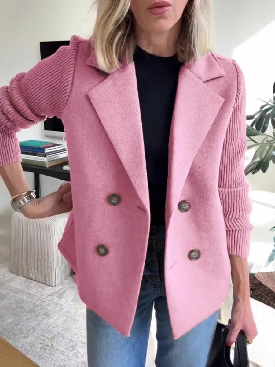 Person wearing a pink coat with a blurred indoor background